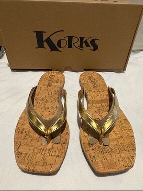 NIB Korks gold flip flop.